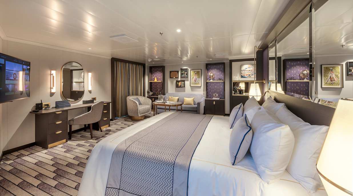 View of the bedroom of a Queens Grill Suite on a Cunard cruise ship